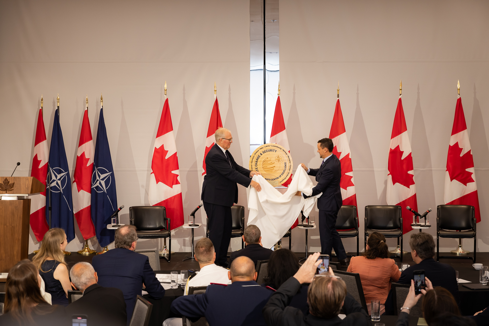 Presentation recognizing CCASCOE's NATO accreditation during the climate and security side event in Washington, D.C.