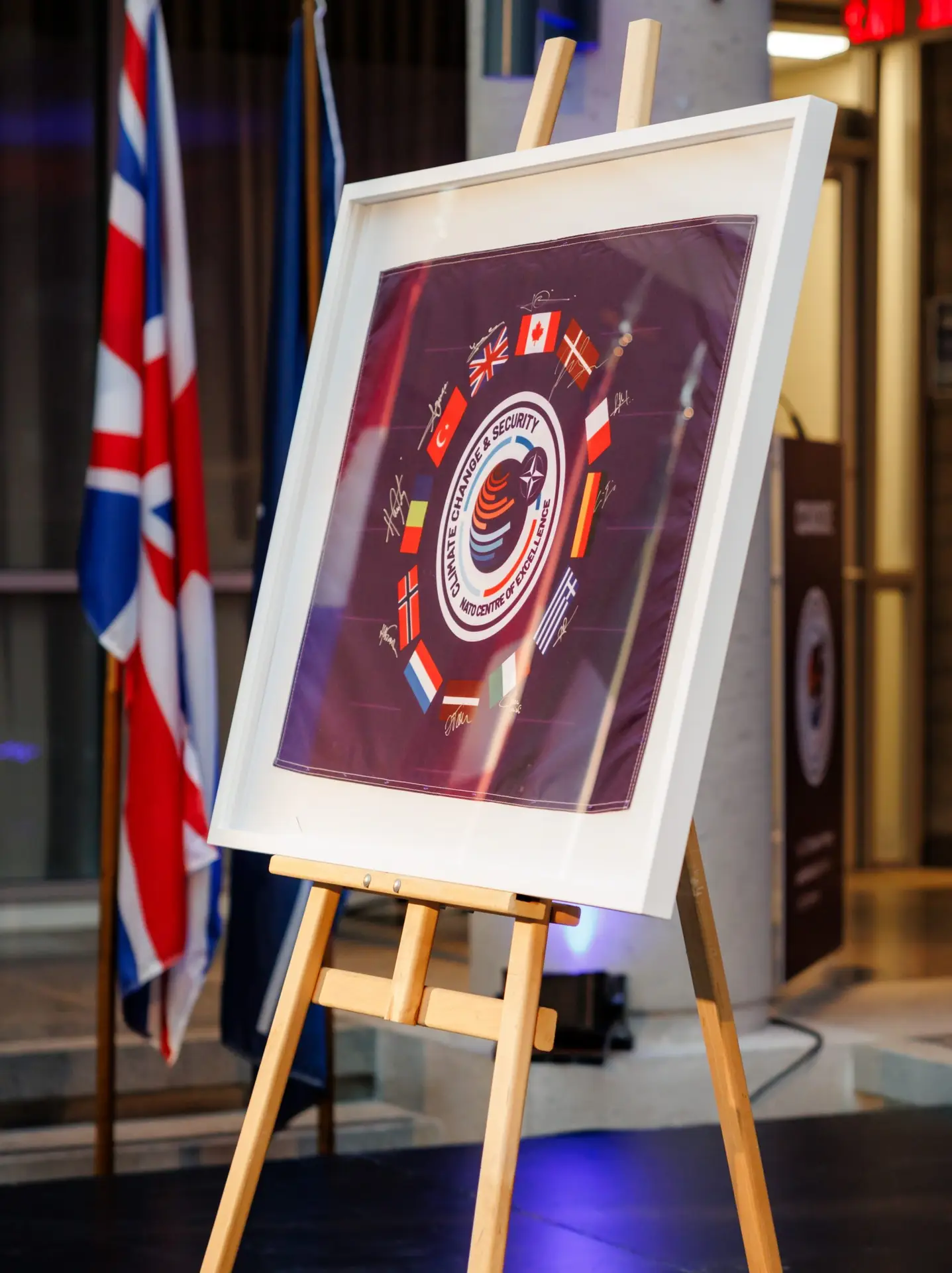 Framed CCASCOE emblem artwork displayed on an easel